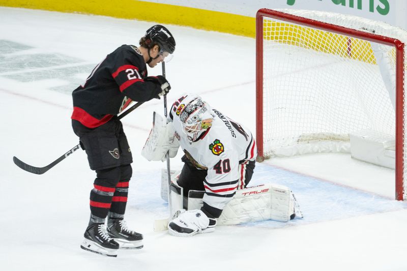 Dec 20, 2025; Ottawa, Ontario, CAN; Chicago Blackhawks goalie Arvid Soderblom (40) covers the puck as Ottawa Senators center Nick Cousins (21) skates by in the third period at the Canadian Tire Centre. Mandatory Credit: Marc DesRosiers-IMAGN Images