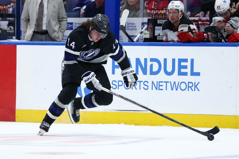 Nov 16, 2024; Tampa, Florida, USA; Tampa Bay Lightning center Conor Geekie (14) controls the puck against the New Jersey Devils in the first period at Amalie Arena. Mandatory Credit: Nathan Ray Seebeck-Imagn Images