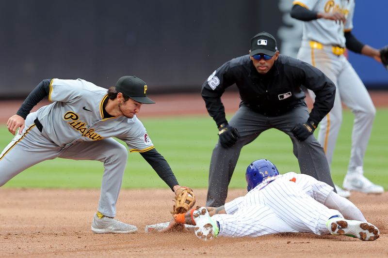 Apr 17, 2024; New York City, New York, USA; New York Mets catcher Francisco Alvarez (4) steals second base ahead of a tag by Pittsburgh Pirates second baseman Alika Williams (25) during the second inning at Citi Field. Mandatory Credit: Brad Penner-USA TODAY Sports