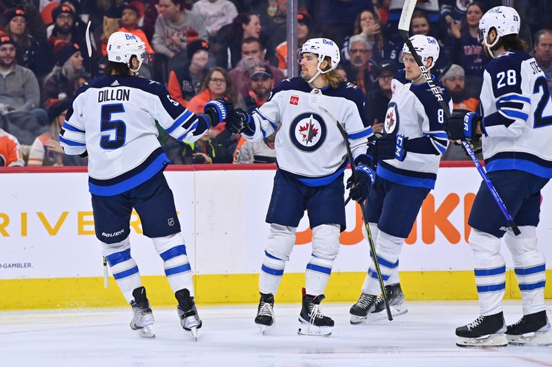 Jan 22, 2023; Philadelphia, Pennsylvania, USA; Winnipeg Jets left wing Axel Jonsson-Fjallby (71) celebrates a goal with defenseman Brenden Dillon (5) against the Philadelphia Flyers in the first period at Wells Fargo Center. Mandatory Credit: Kyle Ross-USA TODAY Sports