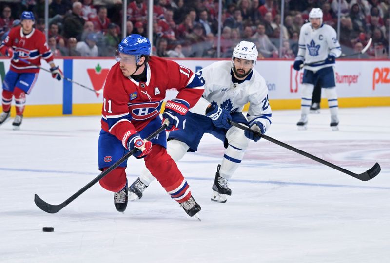 Mar 10, 2026; Montreal, Quebec, CAN; Montreal Canadiens forward Brendan Gallagher (11) plays the puck against Toronto Maple Leafs forward Bo Groulx (29) during the third period at the  Bell Centre. Mandatory Credit: Eric Bolte-Imagn Images
