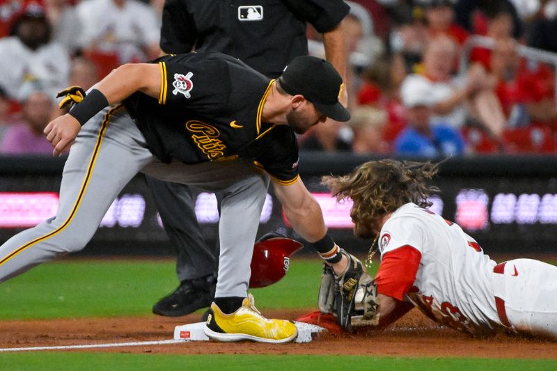 Sep 17, 2024; St. Louis, Missouri, USA;  St. Louis Cardinals left fielder Brendan Donovan (33) slides safely past Pittsburgh Pirates third baseman Jared Triolo (19) for a stolen base during the second inning at Busch Stadium. Mandatory Credit: Jeff Curry-Imagn Images