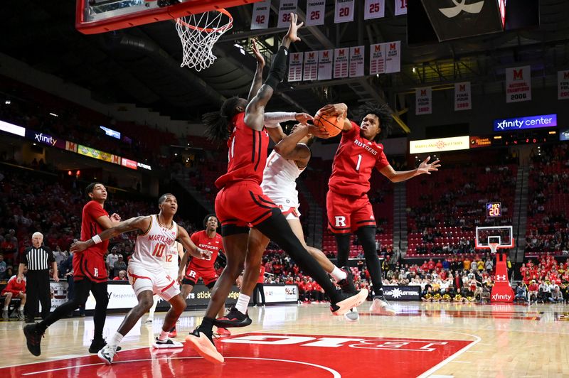 Feb 6, 2024; College Park, Maryland, USA; Rutgers Scarlet Knights guard Jamichael Davis (1) blocks Maryland Terrapins guard Jahmir Young (1) shot during the second half  at Xfinity Center. Mandatory Credit: Tommy Gilligan-USA TODAY Sports