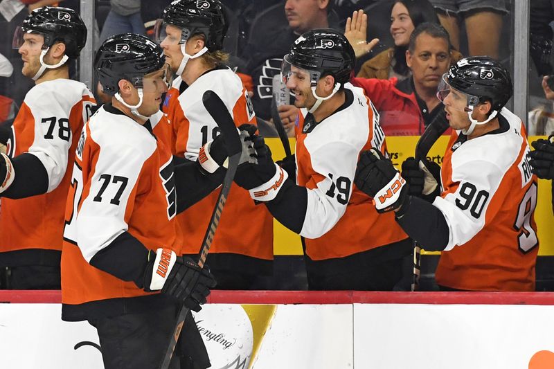 Sep 26, 2024; Philadelphia, Pennsylvania, USA; Philadelphia Flyers defenseman Erik Johnson (77) celebrates his goal with right wing Garnet Hathaway (19) and right wing Anthony Richard (90) against the New York Islanders during the third period at Wells Fargo Center. Mandatory Credit: Eric Hartline-Imagn Images