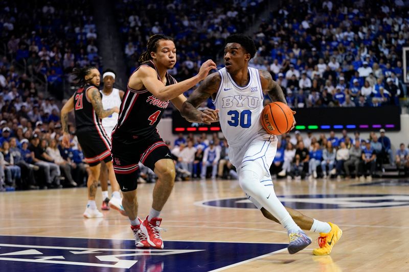 Feb 7, 2026; Provo, Utah, USA; BYU Cougars forward Kennard Davis Jr. (30) drives while being defended by Houston Cougars guard Kingston Flemings (4) during the first half at Marriott Center. Mandatory Credit: Aaron Baker-Imagn Images