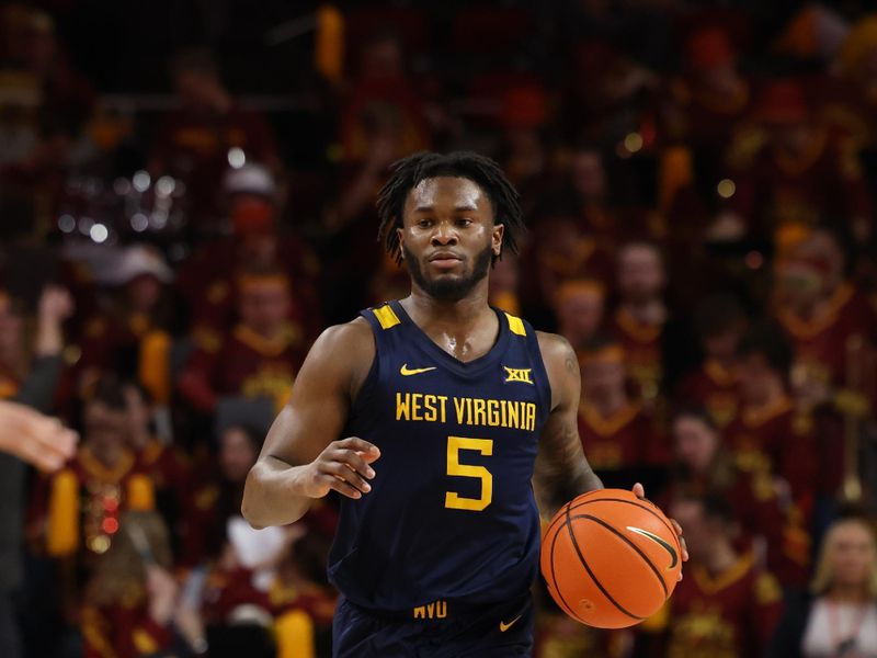 Feb 27, 2023; Ames, Iowa, USA; West Virginia Mountaineers guard Joe Toussaint (5) sets the offense against the Iowa State Cyclones during the first half at James H. Hilton Coliseum. Mandatory Credit: Reese Strickland-USA TODAY Sports