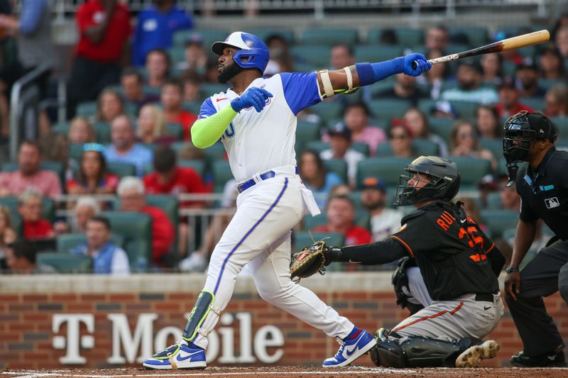 May 6, 2023; Atlanta, Georgia, USA; Atlanta Braves designated hitter Marcell Ozuna (20) hits a home run against the Baltimore Orioles in the third inning at Truist Park. Mandatory Credit: Brett Davis-USA TODAY Sports
