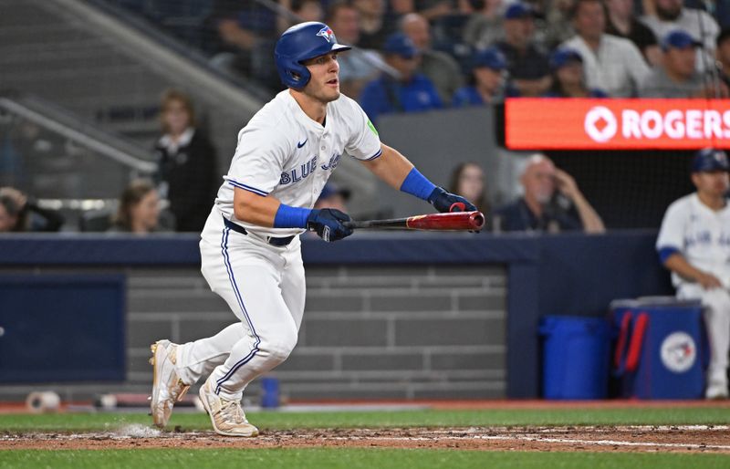 Aug 11, 2024; Toronto, Ontario, CAN; Toronto Blue Jays centre field Daulton Varsho (25) hits a single in the seventh inning against the Oakland Athletics at Rogers Centre. Mandatory Credit: Gerry Angus-USA TODAY Sports