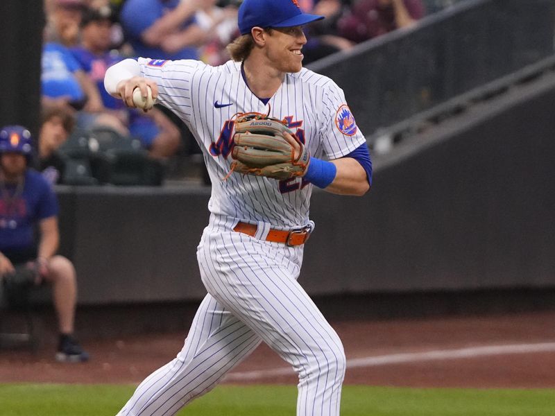 Jul 2, 2023; New York City, New York, USA; New York Mets third Basaman Brett Baty (22) starts a double play on a ball hit by San Francisco Giants second baseman Thairo Estrada (not pictured) during the first inning at Citi Field. Mandatory Credit: Gregory Fisher-USA TODAY Sports