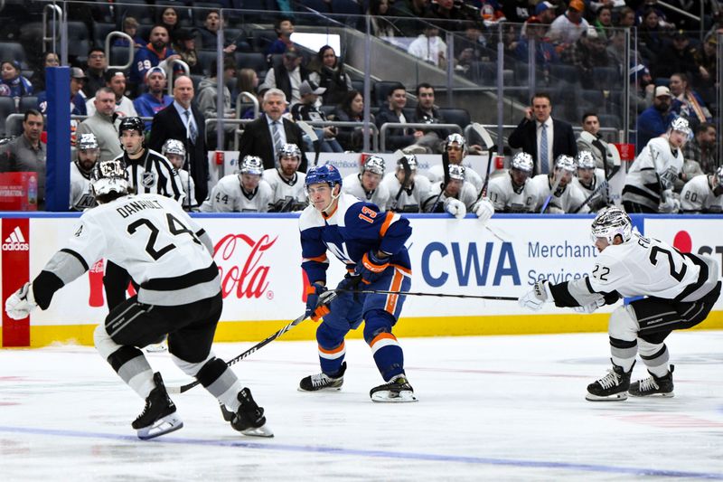 Dec 9, 2023; Elmont, New York, USA; New York Islanders center Mathew Barzal (13) skates with the puck against Los Angeles Kings center Phillip Danault (24) and Los Angeles Kings left wing Kevin Fiala (22) during the second period at UBS Arena. Mandatory Credit: John Jones-USA TODAY Sports