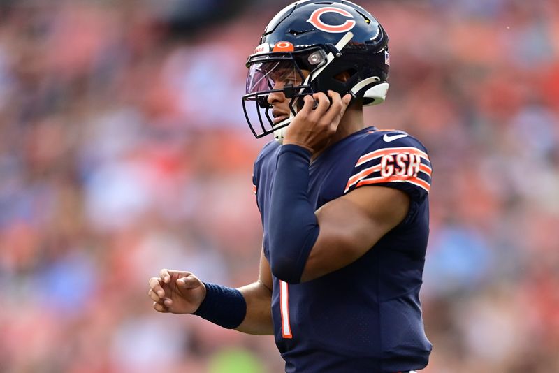 Chicago Bears quarterback Justin Fields (1) prepares for as snap against the Cleveland Browns during the first half of an NFL preseason football game, Saturday, Aug. 27, 2022, in Cleveland. (AP Photo/David Dermer)