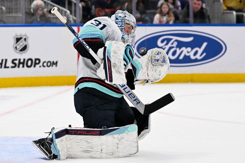 Feb 13, 2024; Elmont, New York, USA; Seattle Kraken goaltender Philipp Grubauer (31) makes a save against the New York Islanders during the overtime period at UBS Arena. Mandatory Credit: Dennis Schneidler-USA TODAY Sports