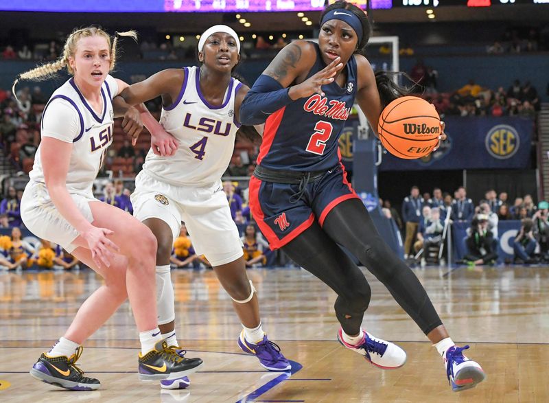 Mar 9, 2024; Greenville, SC, USA; Ole Miss Rebels guard Marquesha Davis (2) drives against LSU Tigers guard Flau'jae Johnson (4) and guard Hailey Van Lith (11) during the fourth quarter at the Bon Secours Wellness Arena. Mandatory Credit: Ken Ruinard/The Greenville News via USA TODAY NETWORK