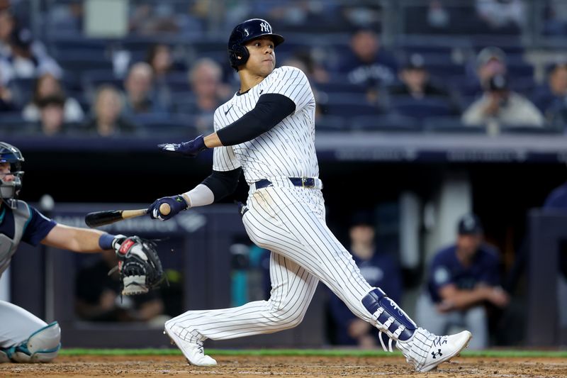 May 20, 2024; Bronx, New York, USA; New York Yankees right fielder Juan Soto (22) follows through on a single against the Seattle Mariners during the fifth inning at Yankee Stadium. Mandatory Credit: Brad Penner-USA TODAY Sports