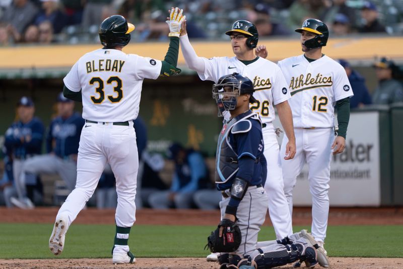 Jun 14, 2023; Oakland, California, USA;  Oakland Athletics left fielder JJ Bleday (33) celebrates with third baseman Jonah Bride (26) and third baseman Aledmys Diaz (12) after hitting a three-run home run during the second inning against the Tampa Bay Rays at Oakland-Alameda County Coliseum. Mandatory Credit: Stan Szeto-USA TODAY Sports