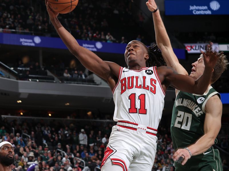MILWAUKEE, WI - NOVEMBER 20: Ayo Dosunmu #11 of the Chicago Bulls drives to the basket during the game against the Milwaukee Bucks on November 20, 2024 at the Fiserv Forum Center in Milwaukee, Wisconsin. NOTE TO USER: User expressly acknowledges and agrees that, by downloading and or using this Photograph, user is consenting to the terms and conditions of the Getty Images License Agreement. Mandatory Copyright Notice: Copyright 2024 NBAE (Photo by Gary Dineen/NBAE via Getty Images).