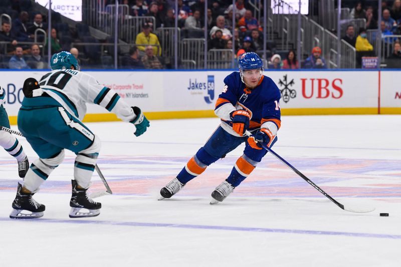 Dec 5, 2023; Elmont, New York, USA; New York Islanders center Bo Horvat (14) skates with the puck defended by San Jose Sharks left wing Fabian Zetterlund (20) during the second period at UBS Arena. Mandatory Credit: Dennis Schneidler-USA TODAY Sports