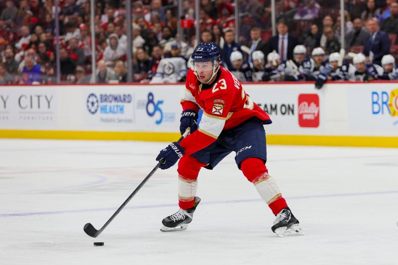 Nov 24, 2023; Sunrise, Florida, USA; Florida Panthers center Carter Verhaeghe (23) moves the puck against the Winnipeg Jets during the second period at Amerant Bank Arena. Mandatory Credit: Sam Navarro-USA TODAY Sports