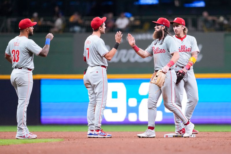 Sep 17, 2024; Milwaukee, Wisconsin, USA;  Philadelphia Phillies left fielder Brandon Marsh (16) greets shortstop Trea Turner (7) following the game against the Milwaukee Brewers at American Family Field. Mandatory Credit: Jeff Hanisch-Imagn Images