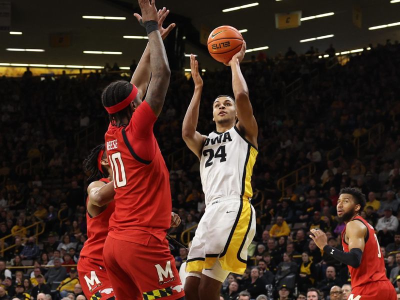 Jan 15, 2023; Iowa City, Iowa, USA; Maryland Terrapins forward Julian Reese (10) defends the shot from Iowa Hawkeyes forward Kris Murray (24) at Carver-Hawkeye Arena.  The Hawkeyes beat the Terrapins 81-67. Mandatory Credit: Reese Strickland-USA TODAY Sports