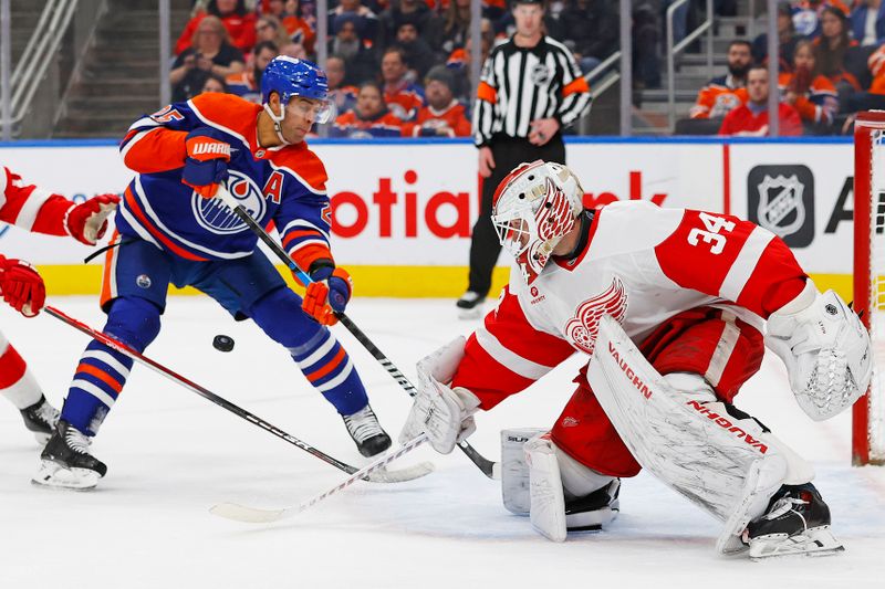 Jan 30, 2025; Edmonton, Alberta, CAN; Edmonton Oilers defensemen Darnell Nurse (25) deflects a shot wide of Detroit Red Wings goaltender Alex Lyon (34) during the third period at Rogers Place. Mandatory Credit: Perry Nelson-Imagn Images