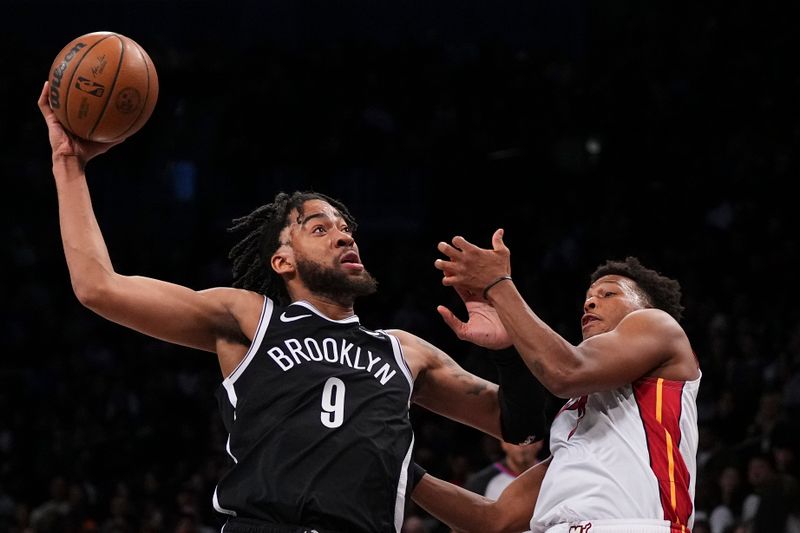 NEW YORK, NEW YORK - NOVEMBER 25: Trendon Watford #9 of the Brooklyn Nets drives to the basket against Kyle Lowry #7 of the Miami Heat in the first half at Barclays Center on November 25, 2023 in the Brooklyn borough of New York City. NOTE TO USER: User expressly acknowledges and agrees that, by downloading and or using this photograph, User is consenting to the terms and conditions of the Getty Images License Agreement. (Photo by Mitchell Leff/Getty Images)