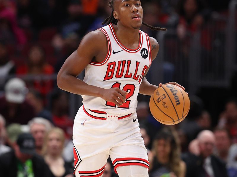 CHICAGO, ILLINOIS - MARCH 11: Ayo Dosunmu #12 of the Chicago Bulls dribbles up the court against the Dallas Mavericks during the second half at the United Center on March 11, 2024 in Chicago, Illinois. NOTE TO USER: User expressly acknowledges and agrees that, by downloading and or using this photograph, User is consenting to the terms and conditions of the Getty Images License Agreement.  (Photo by Michael Reaves/Getty Images)