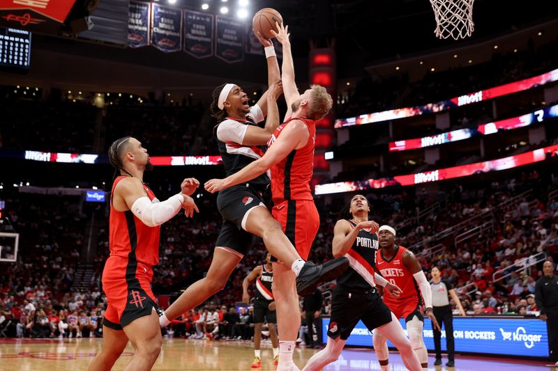 HOUSTON, TEXAS - MARCH 25: Moses Brown #10 of the Portland Trail Blazers drives against Jock Landale #2 of the Houston Rockets in the first half at Toyota Center on March 25, 2024 in Houston, Texas.  NOTE TO USER: User expressly acknowledges and agrees that, by downloading and or using this photograph, User is consenting to the terms and conditions of the Getty Images License Agreement. (Photo by Tim Warner/Getty Images)