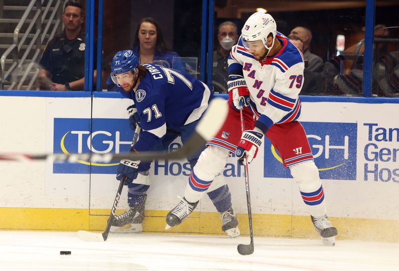 Mar 14, 2024; Tampa, Florida, USA; Tampa Bay Lightning center Anthony Cirelli (71) and New York Rangers defenseman K'Andre Miller (79) fight to control the puck during the first period at Amalie Arena. Mandatory Credit: Kim Klement Neitzel-USA TODAY Sports