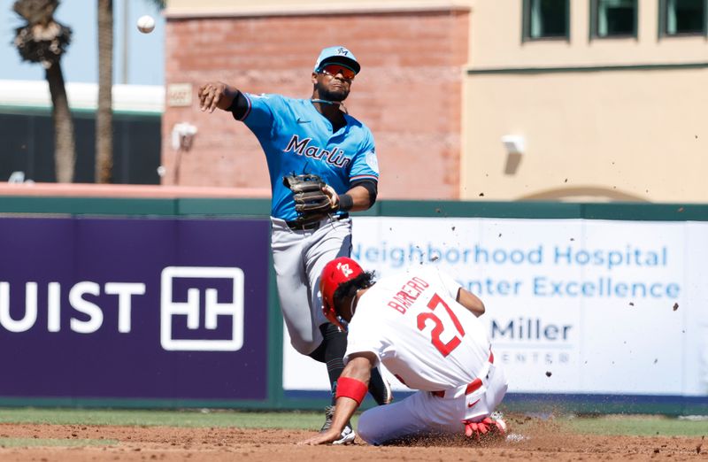 Mar 18, 2025; Jupiter, Florida, USA;  Miami Marlins shortstop Xavier Edwards (9) puts out St. Louis Cardinals short stop Jose Barrero (27) during the during the third inning at Roger Dean Chevrolet Stadium. Mandatory Credit: Rhona Wise-Imagn Images