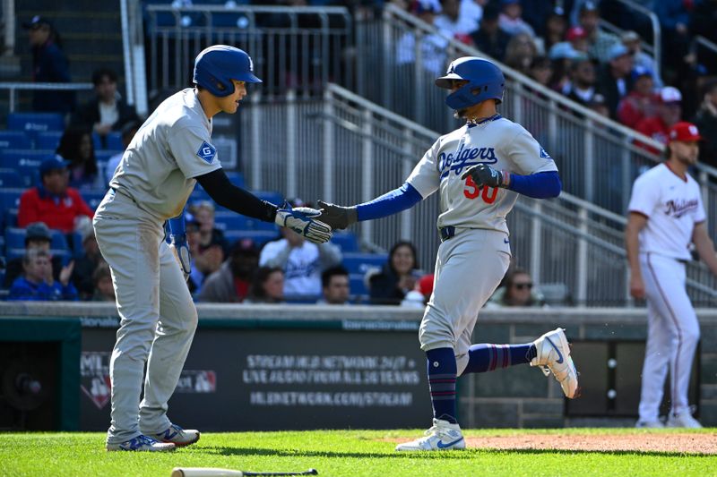 Apr 9, 2025; Washington, District of Columbia, USA; Los Angeles Dodgers shortstop Mookie Betts (50) is congratulated by two-way player Shohei Ohtani (17) after scoring against the Washington Nationals during the first inning at Nationals Park. Mandatory Credit: Brad Mills-Imagn Images