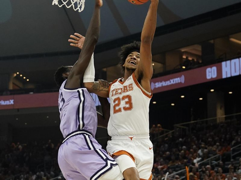 Jan 3, 2023; Austin, Texas, USA; Texas Longhorns forward Dillon Mitchell (23) drives to the basket against Kansas State Wildcats center Abayomi Iyiola (23) during the first half at Moody Center. Mandatory Credit: Scott Wachter-USA TODAY Sports