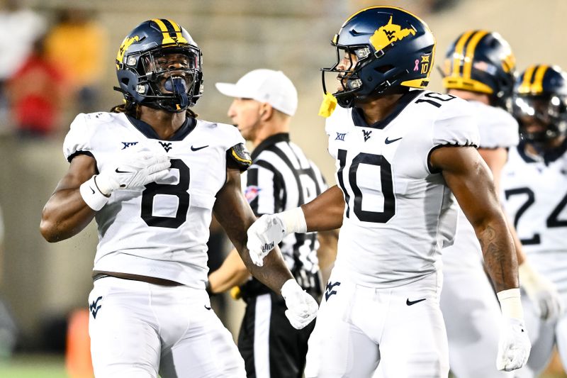 Oct 12, 2023; Houston, Texas, USA; West Virginia Mountaineers linebacker Tyrin Bradley (8) and linebacker Jared Bartlett (10) react during the first quarter against the Houston Cougars at TDECU Stadium. Mandatory Credit: Maria Lysaker-USA TODAY Sports