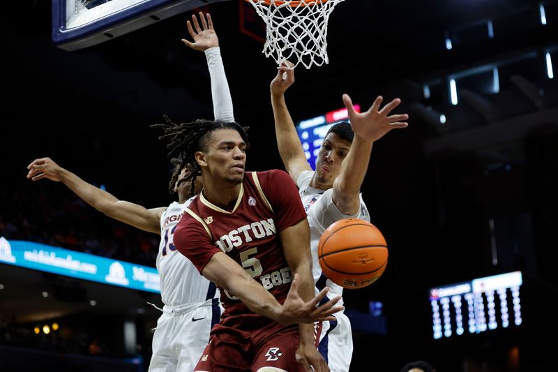 Jan 28, 2023; Charlottesville, Virginia, USA; Boston College Eagles guard DeMarr Langford Jr. (5) leaps to pass the ball as Virginia Cavaliers guard Ryan Dunn (13) and Cavaliers forward Kadin Shedrick (21) defend in the first half at John Paul Jones Arena. Mandatory Credit: Geoff Burke-USA TODAY Sports