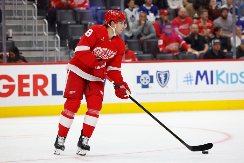 Oct 3, 2024; Detroit, Michigan, USA;  Detroit Red Wings defenseman Ben Chiarot (8) skates with the puck in the first period against the Toronto Maple Leafs at Little Caesars Arena. Mandatory Credit: Rick Osentoski-Imagn Images