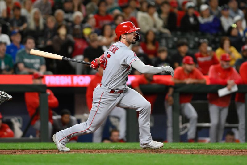 Sep 11, 2023; Seattle, Washington, USA; Los Angeles Angels left fielder Randal Grichuk (15) hits an RBI single against the Seattle Mariners during the eleventh inning at T-Mobile Park. Mandatory Credit: Steven Bisig-USA TODAY Sports