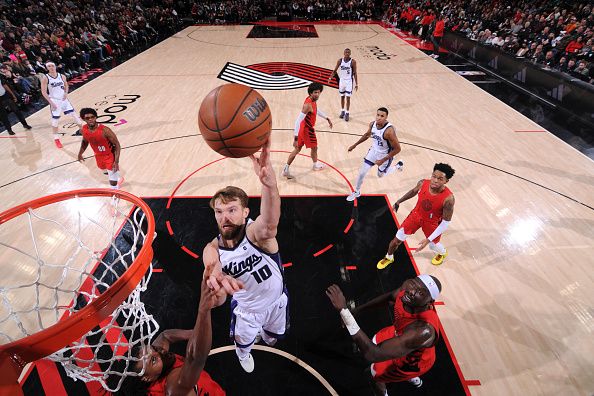 PORTLAND, OR - DECEMBER 26: Domantas Sabonis #10 of the Sacramento Kings drives to the basket during the game against the Portland Trail Blazers on December 26, 2023 at the Moda Center Arena in Portland, Oregon. NOTE TO USER: User expressly acknowledges and agrees that, by downloading and or using this photograph, user is consenting to the terms and conditions of the Getty Images License Agreement. Mandatory Copyright Notice: Copyright 2023 NBAE (Photo by Cameron Browne/NBAE via Getty Images)