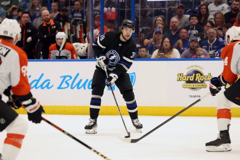 Mar 9, 2024; Tampa, Florida, USA;Tampa Bay Lightning left wing Brandon Hagel (38) passes the puck against the Philadelphia Flyers during the first period at Amalie Arena. Mandatory Credit: Kim Klement Neitzel-USA TODAY Sports