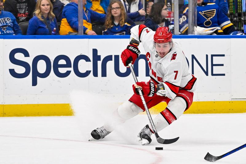 Apr 12, 2024; St. Louis, Missouri, USA;  Carolina Hurricanes defenseman Dmitry Orlov (7) controls the puck against the St. Louis Blues during the third period at Enterprise Center. Mandatory Credit: Jeff Curry-USA TODAY Sports