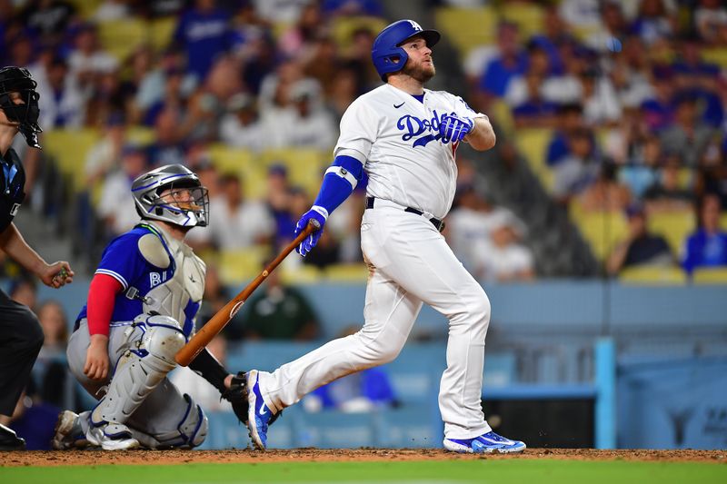 Jul 24, 2023; Los Angeles, California, USA; Los Angeles Dodgers designated hitter Max Muncy (13) hits a solo home run against the Toronto Blue Jays during the eighth inning at Dodger Stadium. Mandatory Credit: Gary A. Vasquez-USA TODAY Sports