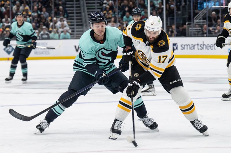 Feb 23, 2023; Seattle, Washington, USA; Boston Bruins forward Nick Foligno (17) battles Seattle Kraken defenseman Will Borgen (3) for the puck during the first period at Climate Pledge Arena. Mandatory Credit: Stephen Brashear-USA TODAY Sports