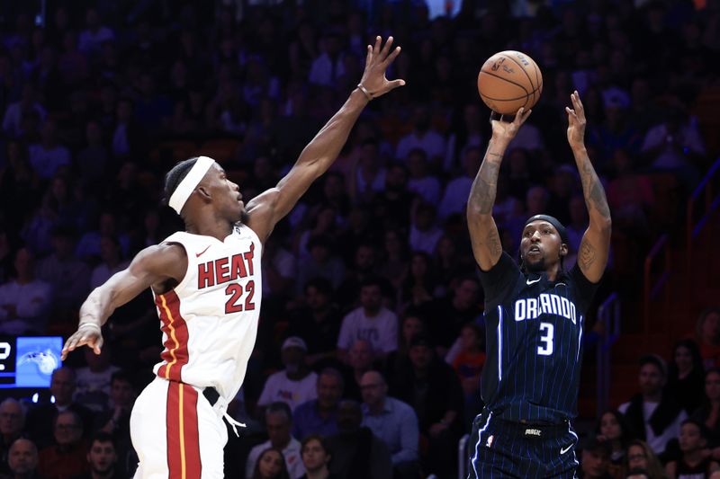 MIAMI, FLORIDA - OCTOBER 23: Kentavious Caldwell-Pope #3 of the Orlando Magic shoots against Jimmy Butler #22 of the Miami Heat during the second half at Kaseya Center on October 23, 2024 in Miami, Florida. NOTE TO USER: User expressly acknowledges and agrees that, by downloading and or using this photograph, User is consenting to the terms and conditions of the Getty Images License Agreement. (Photo by Carmen Mandato/Getty Images)