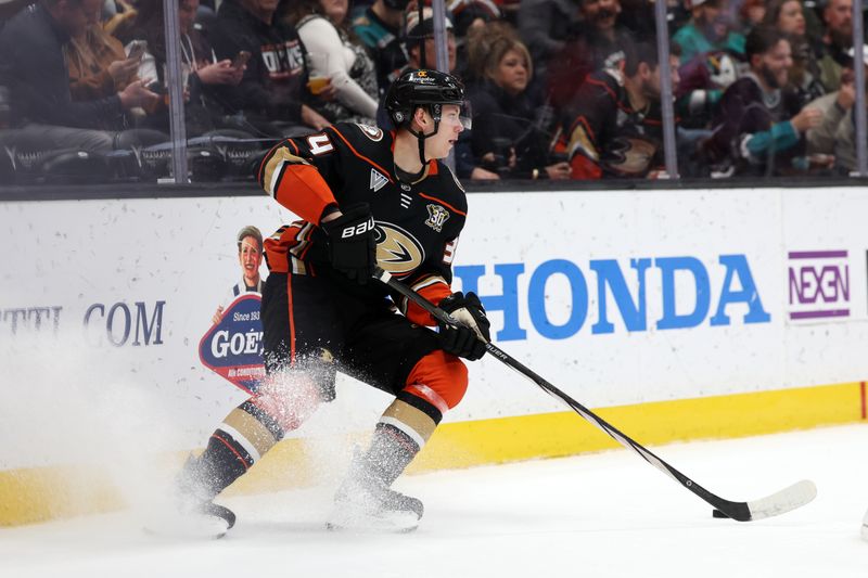 Dec 21, 2023; Anaheim, California, USA;  Anaheim Ducks defenseman Pavel Mintyukov (34) controls the puck during the third period against the Calgary Flames at Honda Center. Mandatory Credit: Kiyoshi Mio-USA TODAY Sports