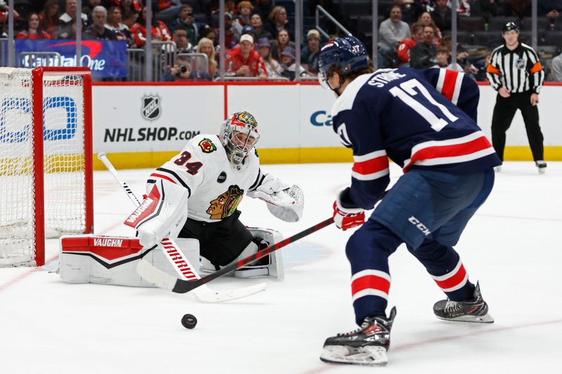 Mar 9, 2024; Washington, District of Columbia, USA; Washington Capitals center Dylan Strome (17) skates with the puck on Chicago Blackhawks goaltender Petr Mrazek (34) in the third period at Capital One Arena. Mandatory Credit: Geoff Burke-USA TODAY Sports