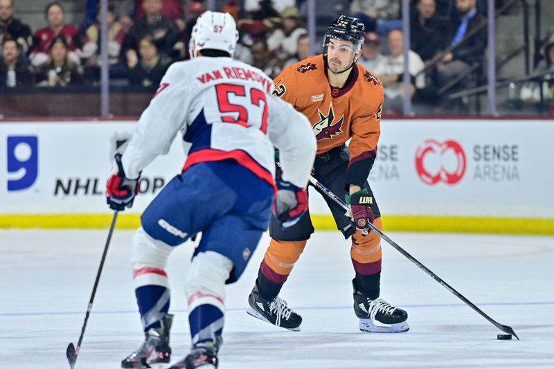 Jan 19, 2023; Tempe, Arizona, USA; Arizona Coyotes center Jack McBain (22) looks to pass as Washington Capitals defenseman Trevor van Riemsdyk (57) defends in the second period at Mullett Arena. Mandatory Credit: Matt Kartozian-USA TODAY Sports