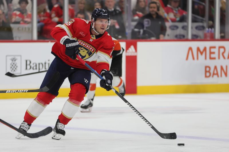 Feb 6, 2024; Sunrise, Florida, USA; Florida Panthers defenseman Dmitry Kulikov (7) moves the puck against the Philadelphia Flyers during the second period at Amerant Bank Arena. Mandatory Credit: Sam Navarro-USA TODAY Sports