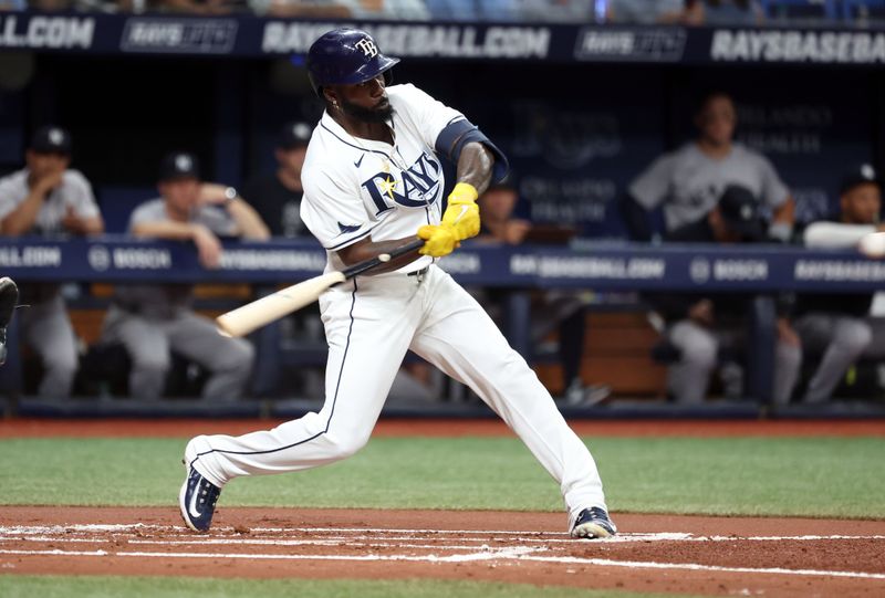 Jul 9, 2024; St. Petersburg, Florida, USA;  Tampa Bay Rays outfielder Randy Arozarena (56) hits a RBI double against the New York Yankees during the first inning at Tropicana Field. Mandatory Credit: Kim Klement Neitzel-USA TODAY Sports