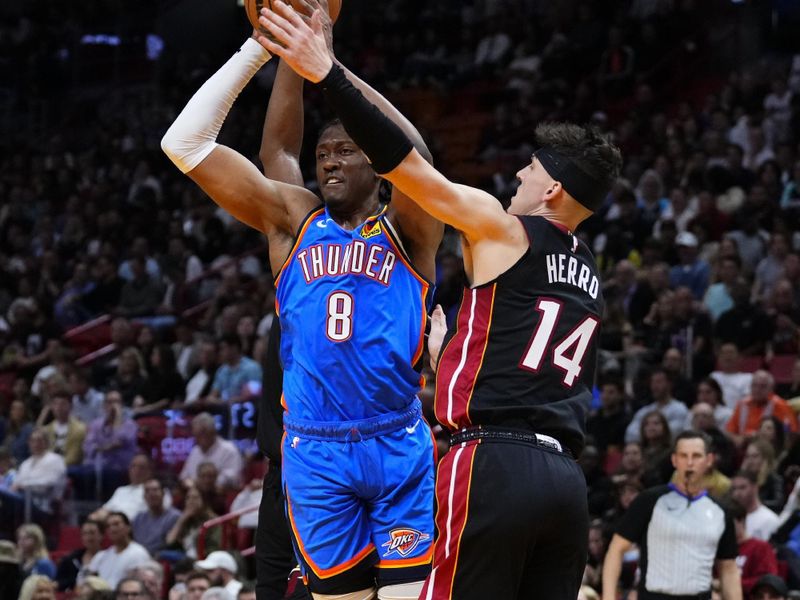 MIAMI, FLORIDA - JANUARY 10: Jalen Williams #8 of the Oklahoma City Thunder throws a pass against Tyler Herro #14 of the Miami Heat during the first half at Kaseya Center on January 10, 2024 in Miami, Florida. NOTE TO USER: User expressly acknowledges and agrees that, by downloading and or using this photograph, User is consenting to the terms and conditions of the Getty Images License Agreement. (Photo by Rich Storry/Getty Images)