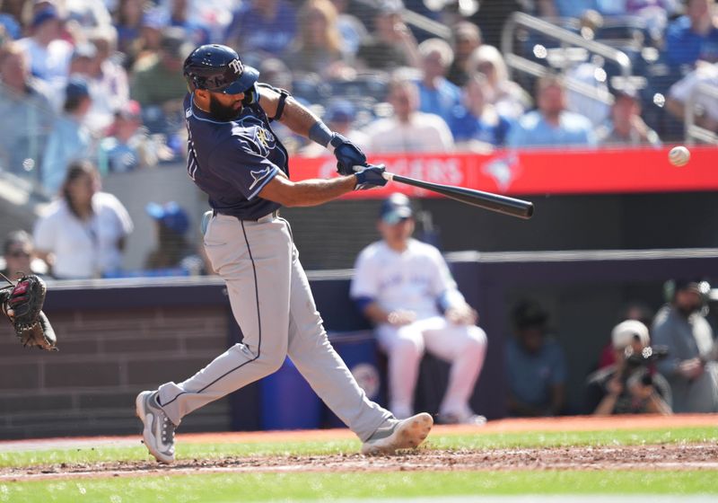 May 18, 2024; Toronto, Ontario, CAN; Tampa Bay Rays second baseman Amed Rosario (10) hits a two run single against the against the Toronto Blue Jays during the sixth inning at Rogers Centre. Mandatory Credit: Nick Turchiaro-USA TODAY Sports