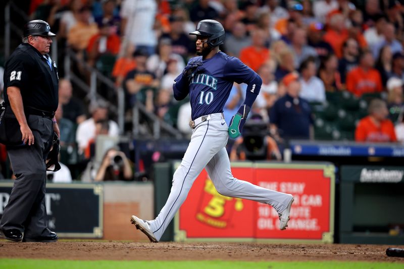 Sep 25, 2024; Houston, Texas, USA; Seattle Mariners right fielder Victor Robles (10) crosses home plate to score  a run against the Houston Astros during the sixth inning at Minute Maid Park. Mandatory Credit: Erik Williams-Imagn Images